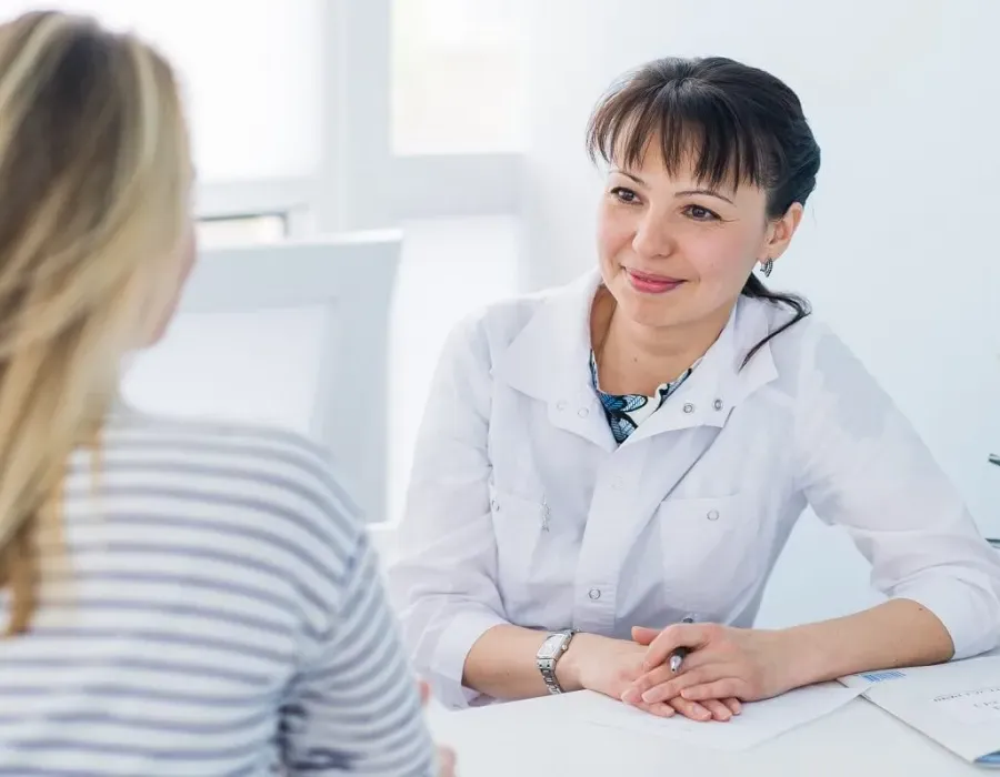 Adult Gerontology nurse practitioner smiling during appointment with patient